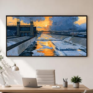 May include: A rectangular wall art print featuring an oil painting of a concrete canal at sunset. The scene depicts a bridge, industrial structures, and power lines under a vibrant orange and blue sky, with reflections on the water surface.