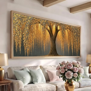 May include: A rectangular wall art piece featuring a large tree with textured, golden-yellow leaves cascading downward against a dark, moody background. The tree has a thick, detailed brown trunk and branches, framed in a light-colored wooden frame.
