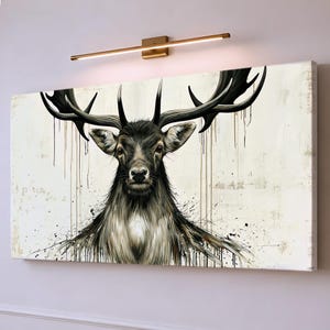 May include: A rectangular canvas wall art print featuring a detailed illustration of a deer with large antlers. The deer is rendered in shades of black, gray, and white with paint drip effects against a cream-colored background.
