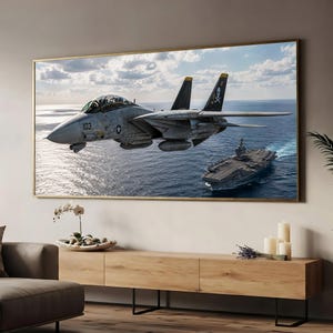 May include: A rectangular wall art print featuring a gray F-14 Tomcat fighter jet flying over the ocean near an aircraft carrier. The jet displays the number 103 on its nose and a skull and crossbones emblem on its vertical stabilizer tail fin.
