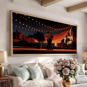 May include: A rectangular framed wall art print depicting a couple dancing on a terrace at night. The scene features warm orange and dark blue tones, illuminated by strings of glowing lights against a dark sky, with silhouettes of buildings.