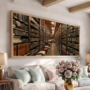 May include: A rectangular wall art print featuring a perspective view of a long, narrow archive room with tall wooden shelves packed with numerous rolled documents and leather-bound books, illuminated by a series of warm overhead pendant lights.