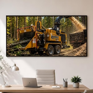 May include: A yellow Bandit Intimidator 18XP wood chipper machine operating in a forest, processing tree branches into wood chips that are being discharged into a black dump truck trailer parked alongside the heavy industrial equipment.