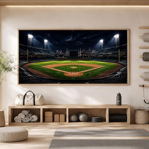 May include: A rectangular wall art print featuring a night view of a baseball stadium with bright floodlights illuminating the green field and dirt diamond. The stadium is surrounded by dark stands and a distant city skyline under a night sky.