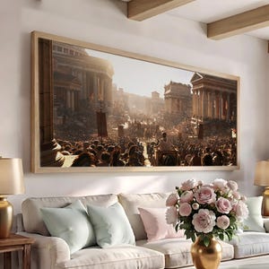 May include: A rectangular framed wall art print depicting a crowded ancient Roman city scene with classical architecture, stone columns, and a chariot in the center. The artwork features warm golden sunlight, detailed figures, and a light wooden frame.