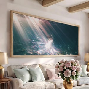 May include: A rectangular wall art piece in a light wood frame featuring an underwater scene with a figure in a flowing white dress. Beams of light penetrate the dark blue water, illuminating the figure and creating a shimmering, ethereal effect.