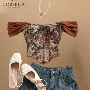 May include: A corset top with a floral tapestry pattern and brown off-the-shoulder sleeves, a double-strand pearl necklace with a circular pendant, a pair of cream-colored slingback flats with bows, and a dark blue denim pleated mini skirt.