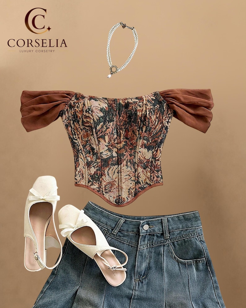 May include: A corset top with a floral tapestry pattern and brown off-the-shoulder sleeves, a double-strand pearl necklace with a circular pendant, a pair of cream-colored slingback flats with bows, and a dark blue denim pleated mini skirt.