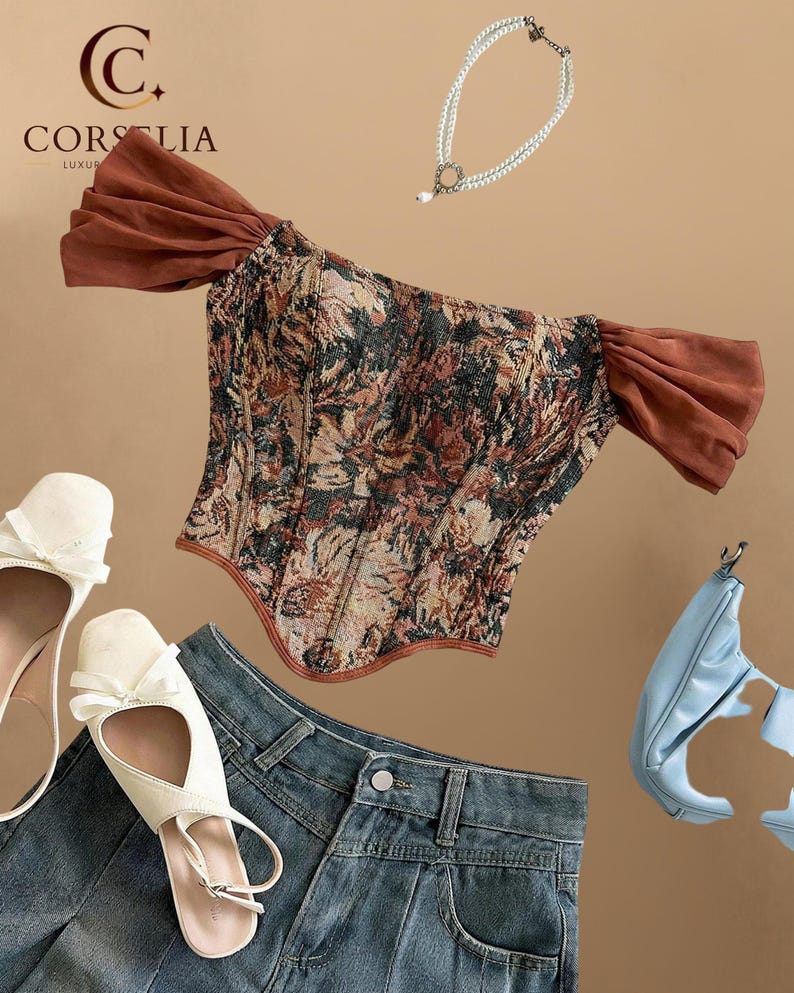 May include: A floral tapestry corset top with brown off-the-shoulder sleeves, a double-strand pearl necklace, white bow-accented flats, blue denim jeans, and a light blue handbag. The Corselia logo is visible in the upper left corner.