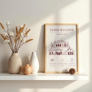 May include: A framed print titled Danse Macabre Efteling featuring a detailed architectural illustration of a building, with text detailing attraction, manufacturer, and opening date, displayed next to two ceramic vases and dried flowers.