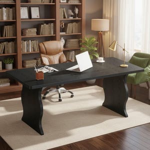 May include: A large rectangular black wooden desk with a smooth surface and curved side supports. The desk features a white laptop, a brown pen holder, and an open book on its top. It is positioned in a room with a brown leather office chair.