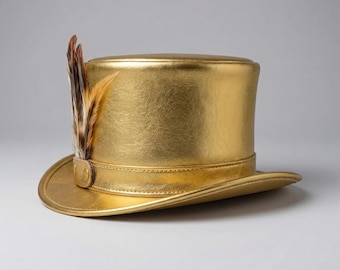 May include: A metallic gold top hat featuring a structured crown and a curved brim. A matching gold band encircles the base of the crown, adorned with a cluster of brown, black, and cream-colored feathers secured by a small gold tab.