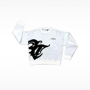 May include: A white long-sleeve crewneck sweater featuring a large black abstract graphic on the lower left side and the word Amiri embroidered in a cursive script on the upper right chest. The garment has a ribbed collar, cuffs, and hem.