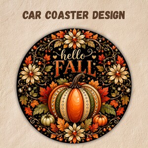 May include: A circular car coaster featuring the text "hello FALL" in a decorative font. The design includes a central orange pumpkin surrounded by autumn leaves, white flowers, and small sparkling accents on a black background.