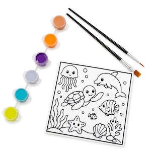 May include: A square colouring canvas featuring black and white line art of sea creatures including a jellyfish, turtle, dolphin, fish, and starfish. The set includes a strip of six small paint pots in yellow, blue, light blue, purple, orange, and tan, plus two black paintbrushes.