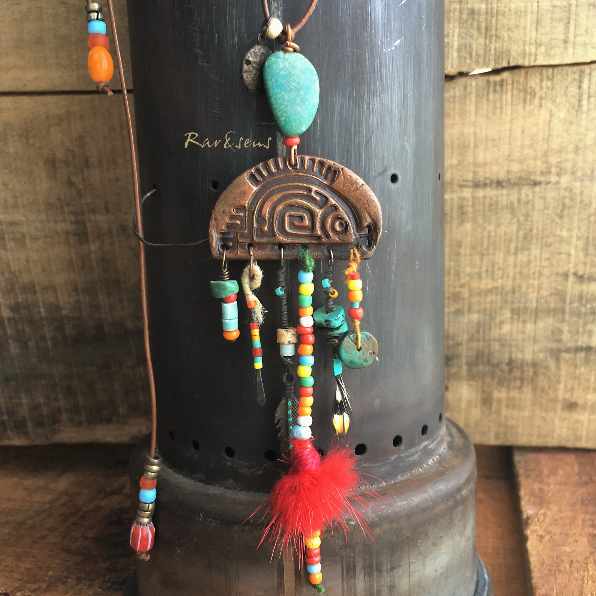 Long necklace with small copper fis