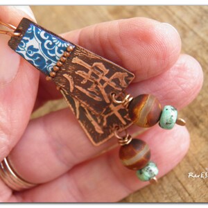 May include: Copper earrings with blue and white patterned metal, brown and white agate beads, and turquoise beads.