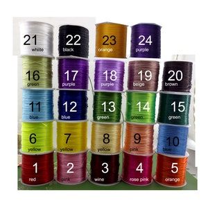 May include: Twenty-four spools of elastic cord in various colours, numbered 1 through 24. The colours include red, pink, wine, rose pink, orange, yellow, blue, green, purple, beige, brown, white, and black.