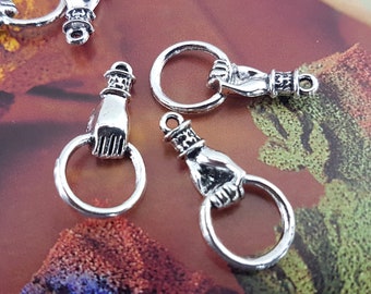 May include: Silver charm pendants shaped like a hand with a ring. The charms are ideal for jewellery making or adding a unique touch to crafts.