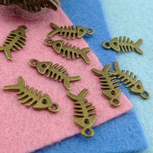 fish skeleton bronze tone charms,fish bone statement charm patina bronze,aquatic beauty bronze tone charm,aquatic marine life symbol charm