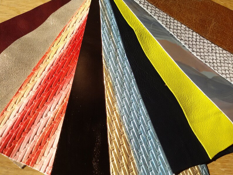 May include: A collection of 12 different leather samples, each with a unique texture and colour. The samples are arranged in a fan shape, with the darkest colour at the bottom and the lightest colour at the top.