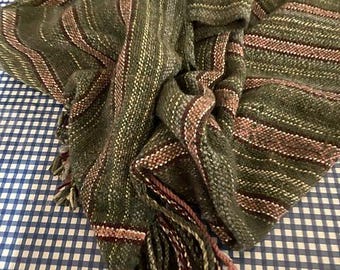 May include: A green and pink striped woven throw blanket with fringe tassels.