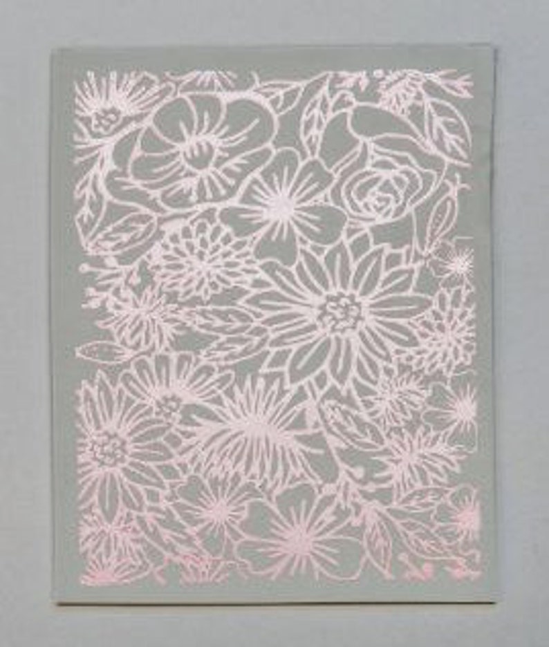 May include: A pink and gray floral pattern with a variety of flowers and leaves. The pattern is embossed on a card.