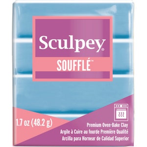 May include: A blue block of Sculpey Souffle brand oven-bake clay. The package is pink and white and says "1.7 oz (48.2 g)" and "Premium Oven-Bake Clay".
