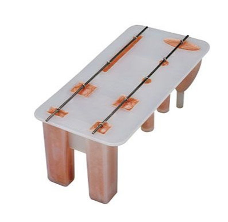 May include: White plastic popsicle mold with four individual molds and metal sticks. The mold is filled with a light orange liquid.
