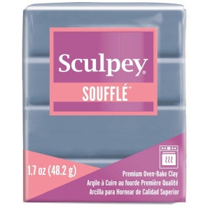May include: A 1.7 ounce (48.2 gram) block of Sculpey Souffle oven-bake clay in a light blue color. The packaging features the Sculpey logo and the text "Souffle" in pink.