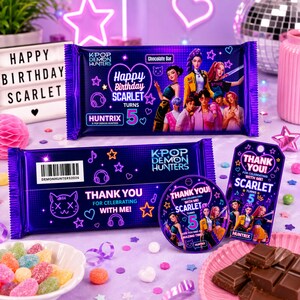 May include: A purple K-Pop Demon Hunters chocolate bar wrapper, a matching rectangular thank you label, and a circular thank you sticker. The designs feature anime-style characters, the text Happy Birthday Scarlet Turns 5, and neon graphics.