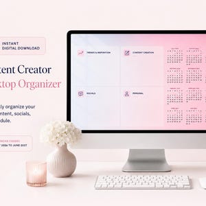 May include: A computer monitor displaying a digital desktop organiser with a pink gradient background, featuring sections for trends, content creation, socials, and personal tasks, alongside a calendar from July 2026 to June 2027, with text reading Content Creator Desktop Organiser.