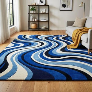 May include: A rectangular area rug featuring a repeating pattern of flowing, wavy lines in shades of navy blue, royal blue, light blue, and cream. The design consists of thick, curved bands that span the entire surface of the floor covering.
