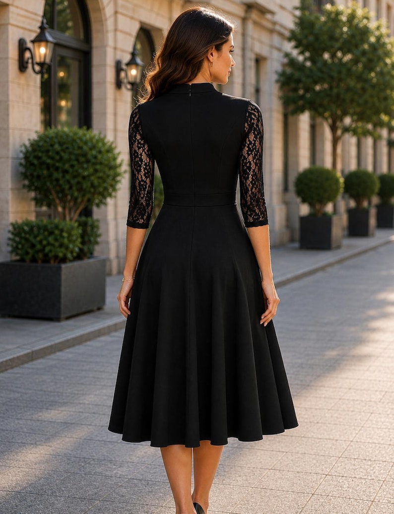 Puede incluir: Un vestido midi negro con cuello alto, mangas tres cuartos con detalles de encaje negro intrincado y falda acampanada. La prenda presenta un corpi&ntilde;o ajustado y una parte posterior negra s&oacute;lida con un cierre de cremallera central en la espalda.