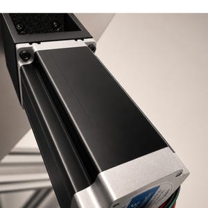 May include: A black stepper motor with a silver metal end cap and a blue label featuring the CE mark. The motor has a square profile with four visible black screws at the mounting point and a bundle of red, green, blue, and black wires extending.