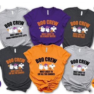 May include: Six short-sleeved crew neck t-shirts in light gray, purple, dark gray, and orange. Each shirt features a graphic of three ghosts and the text BOO CREW with various phrases including MOST LIKELY TO DRINK PUMPKIN SPICE LATTE, BE A SASSY WITCH, TRICK OR TREAT, or EAT ALL THE CANDIES.