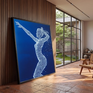 May include: A large rectangular framed wall art piece featuring a deep blue background with a central figure composed of numerous small white dots. The figure is depicted in a dynamic pose with one arm extended upward, creating a digital effect.