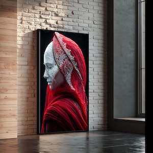 May include: A framed wall art print featuring a profile view of a pale, textured figure draped in a vibrant red fabric head covering. The figure displays intricate white line patterns across the face and head, set against a deep black background.