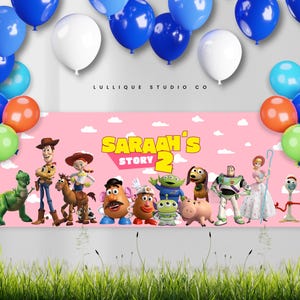 May include: A rectangular pink banner featuring the text "SARAAH'S STORY 2" surrounded by Toy Story characters including Woody, Buzz Lightyear, Jessie, and Mr. Potato Head, framed by a colorful balloon arch in blue, white, orange, green, and pink.