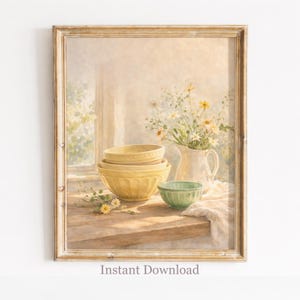 Puede incluir: Impresión enmarcada de un bodegón con cuencos para mezclar amarillos y verdes sobre una mesa de madera. Una jarra blanca contiene un ramo de flores blancas y amarillas. El texto "Instant Download" está impreso en la parte inferior.