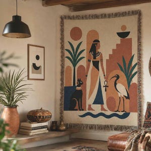 May include: A woven wall tapestry featuring an Egyptian-inspired scene with a central figure, a black cat, and an ibis bird. The design includes geometric shapes, palm trees, and an ankh symbol in shades of terracotta, teal, black, and cream.