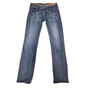 May include: Blue denim jeans featuring a faded wash on the thighs, a button and zipper fly closure, five pockets, and a patterned interior waistband lining. The jeans have a straight-leg cut with visible stitching details and metal rivets.
