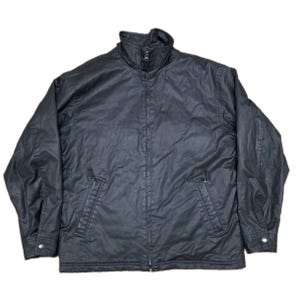 May include: A solid black jacket featuring a high collar, a full-length front zip closure, and two slanted side pockets with zips. The long sleeves have adjustable cuffs with metal snap buttons, and the fabric has a subtle sheen.