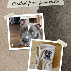 May include: A pair of beige ribbed socks featuring a detailed embroidered portrait of a gray pit bull with a white forehead stripe. The image includes a photograph of the dog and the text Created from your photo on a piece of tape.