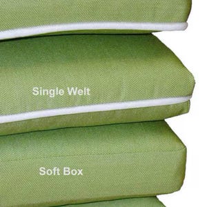 May include: Four green cushions with different edge styles: Double Welt, Single Welt, Soft Box, and Knife Edge. The cushions are stacked on top of each other.