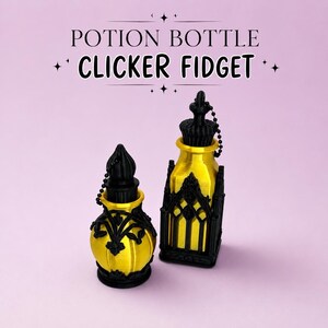May include: Two potion bottle clicker fidget toys with metallic gold bodies and matte black decorative cages. The text POTION BOTTLE CLICKER FIDGET is displayed above the objects. Each bottle features a black cap attached by a small chain.
