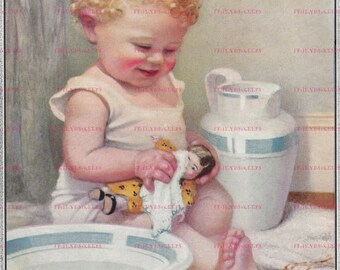 May include: A young child with curly blonde hair is sitting in a white porcelain basin. The child is holding a doll and a white washcloth. There is a white pitcher with a blue stripe on the side behind the child.