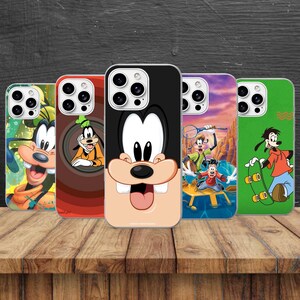 May include: Five smartphone cases featuring the Disney character Goofy. The designs include a close-up of Goofy's face, Goofy peeking through a circular frame, a full-body illustration of Goofy playing tennis, and Goofy riding a skateboard.