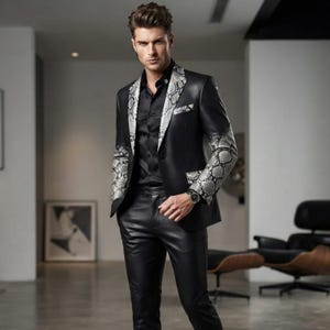 May include: A black blazer featuring a grey and black snakeskin pattern on the lapels and sleeves, paired with a black button-down shirt and black trousers. The blazer has a notched lapel, a chest pocket, and two front pockets with matching trim.