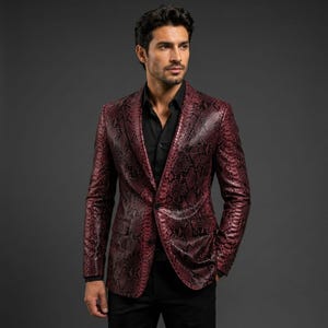 May include: A burgundy and black snakeskin patterned blazer with a notched lapel, two front flap pockets, and a single button closure. The blazer is worn over a solid black button-down shirt with long sleeves and a standard collar.